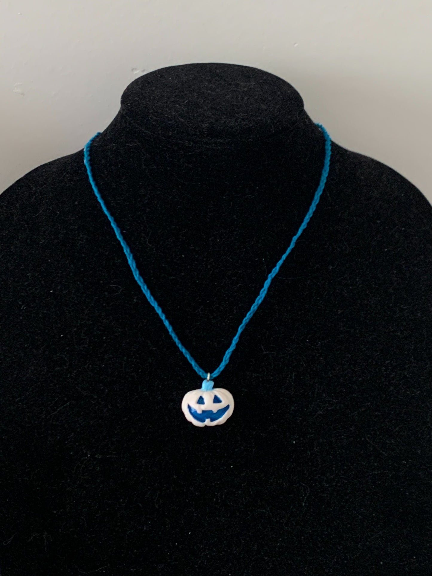 Frosted Winter Jack-O-Lantern Necklace, White Pumpkin, Blue Cotton Cord