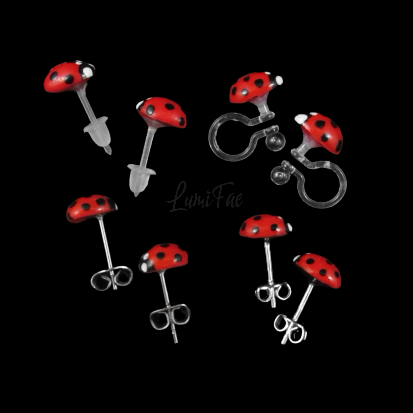 Red and black ladybug earrings on a black background