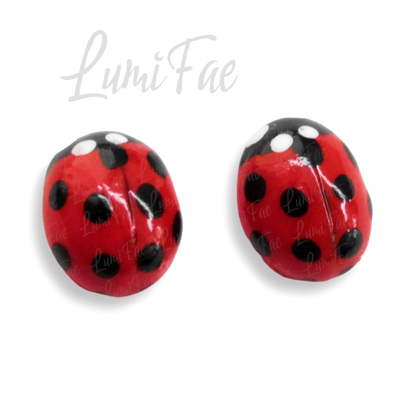 Super close up of details on bright red glossy handmade ladybug stud earrings shown on white background