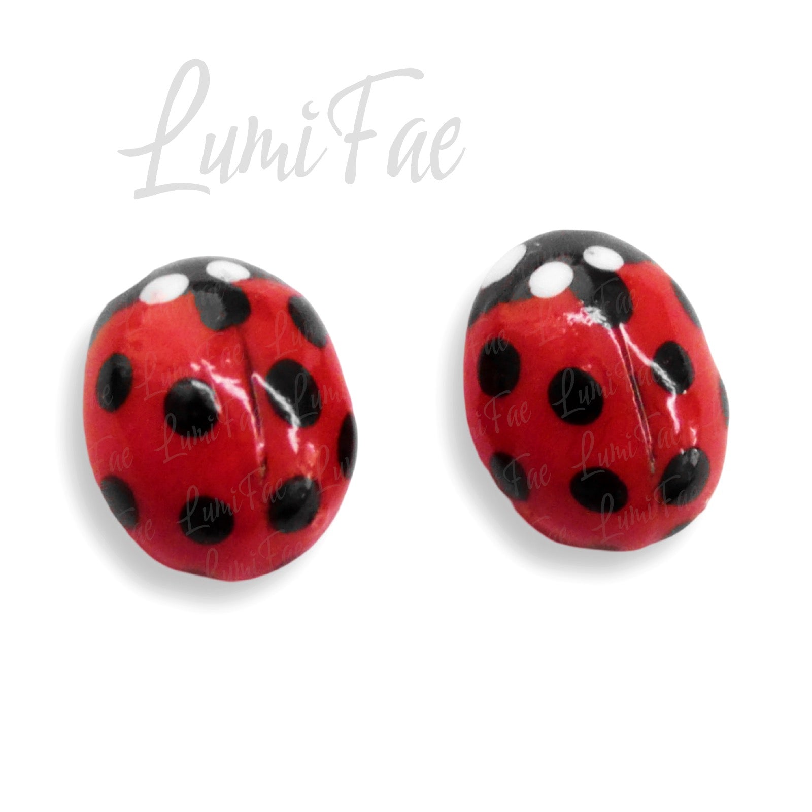 Super close up of details on bright red glossy handmade ladybug stud earrings shown on white background